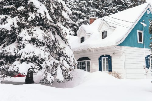 house covered with white snow during winter