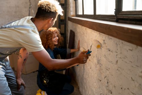 Couple painting their new home after the new year